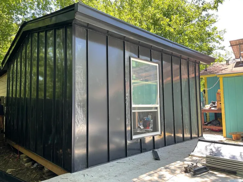 Black standing seam metal wall panels for Roof Inspection in National City